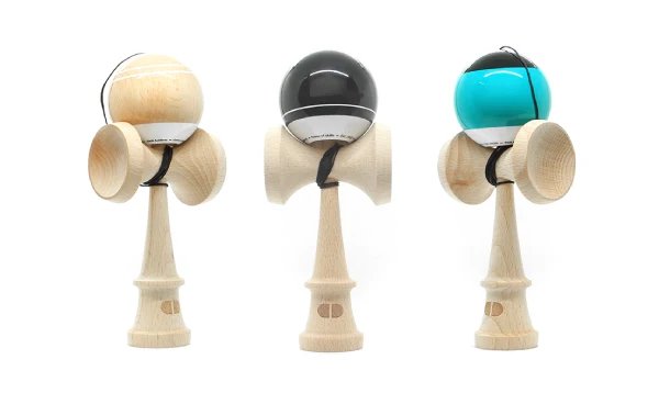 Three wooden kendamas with natural, black and teal balls