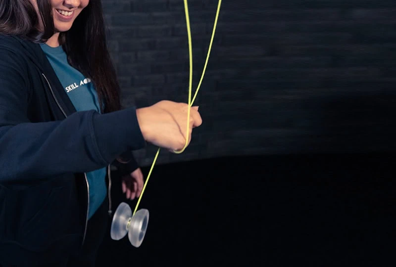 Player doing the Jade Whip with a clear yoyo and yellow string