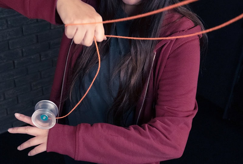 Clear yoyo grinding on the back of the hand in the Prague Grind