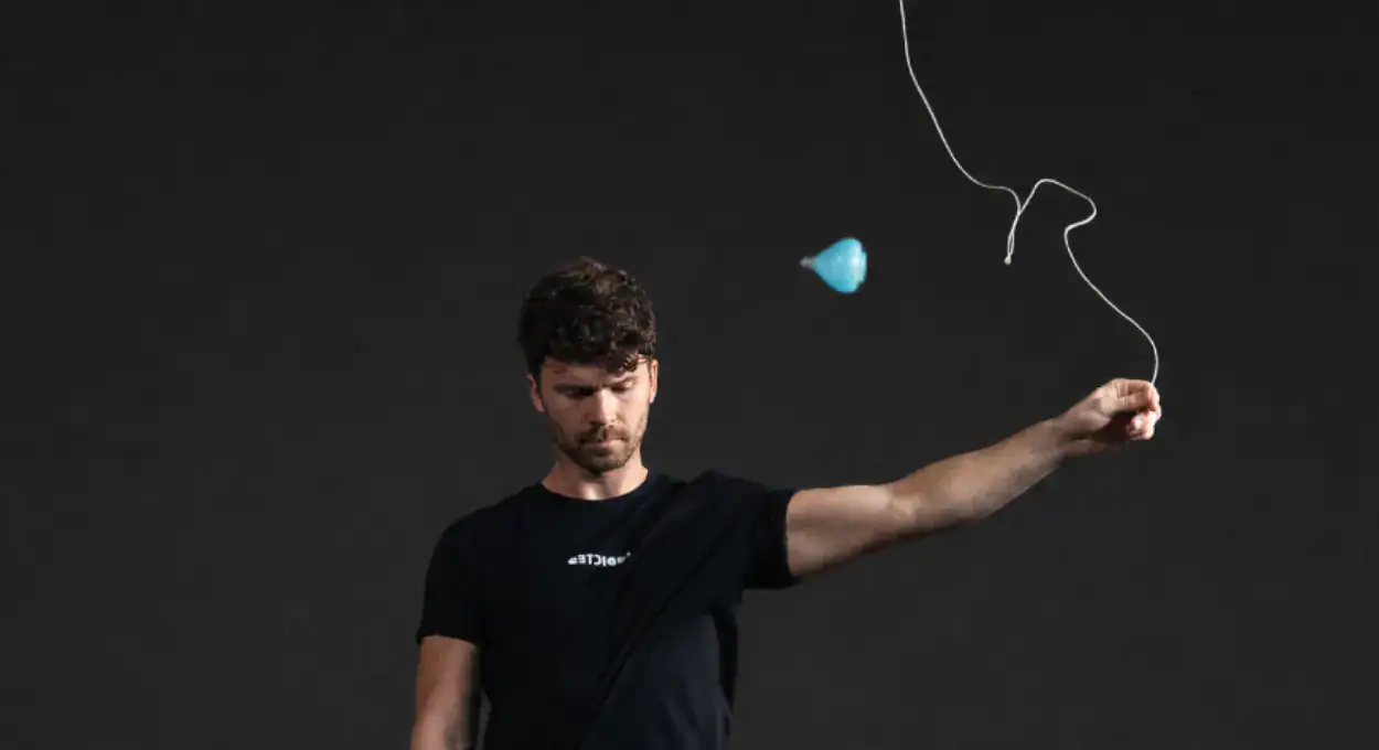 Player throwing the Ball Bearing Spin Top on its string