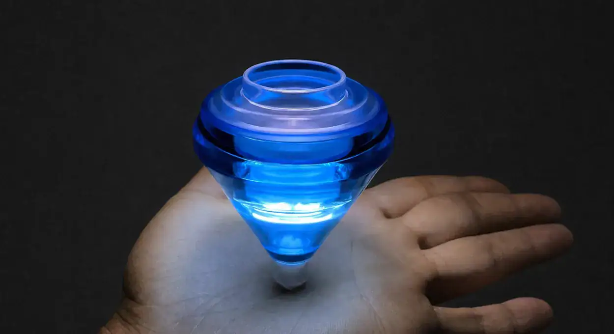 Elec-Trick LED Spin Top glowing blue on a hand