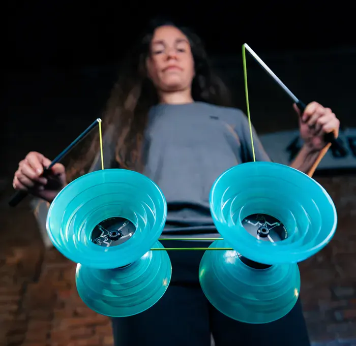 Player spinning a teal Fixed Diabolo on the string