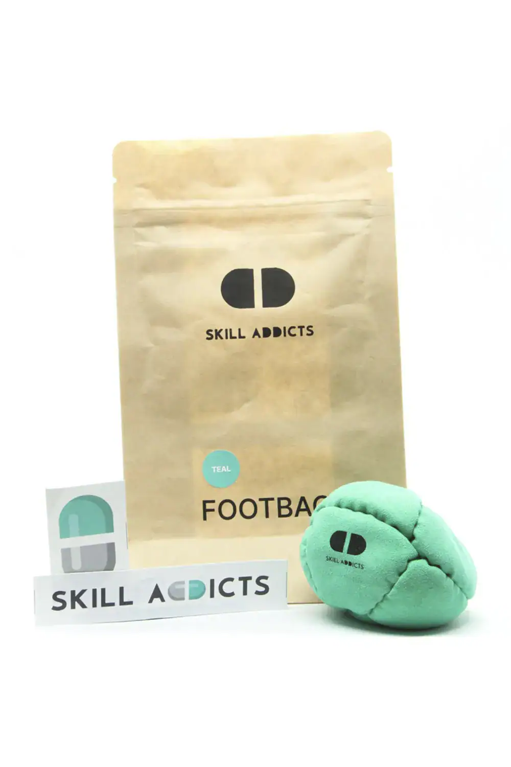 Starter Footbag in teal with its kraft paper bag and sticker