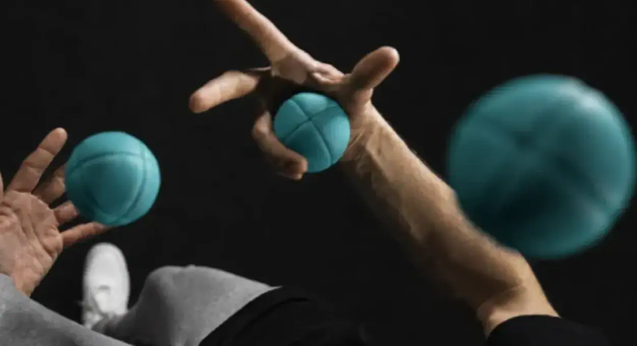 Hands throwing and catching teal Starter Juggling Balls